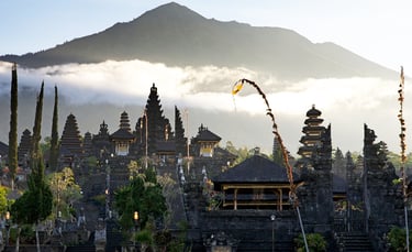 Besakih Temple gates made of black volcanic stone against a clear blue sky