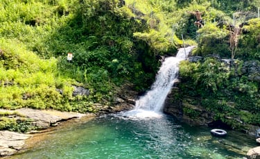 a man is standing in front of a waterfall