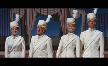 Circus set still from Jumbo (1962) with Doris Day, Jimmy Durante, and cast in white military‑style o