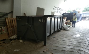 a man standing in front of a large metal container