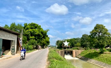 a person riding a motorcycle down a narrow road