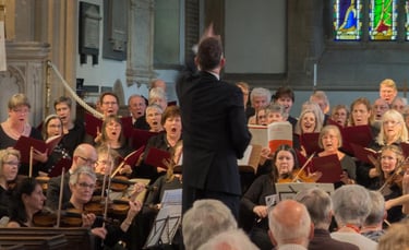 Photo of Steven Kings conducting a choir and orchestra