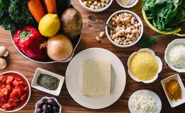 a table with bowls of food and vegetables