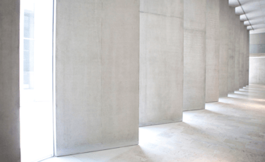 a room with a large window and a wall with a long row of stairs