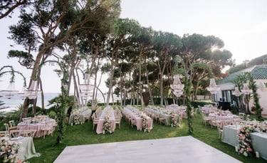 Seaside wedding reception setup at Villa El Rincon Marbella with chandeliers and floral décor