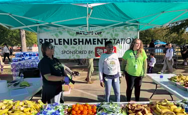 A photo of volunteers working the replenishment and aid station at the Tuscaloosa Mayor's Cup