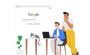 a man and woman sitting at a desk with a laptop