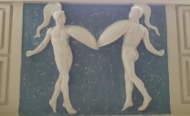 Two dancers depicted in the plaster decoration at Braxted Park