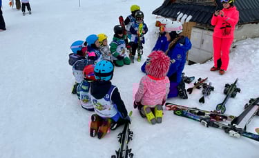 a group of children and adults in skis and snow gear
