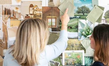 Interior designers review a green mood board with fabric swatches and nature photography for home decor inspiration.