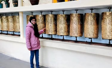 Tibetan prayer wheels at the Dalai Lama Temple in McLeod Ganj, Dharamshala, symbolizing peace, faith, and Buddhist tradition.