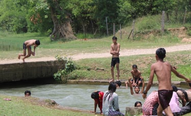 children bathing in the river at Thakurdwara