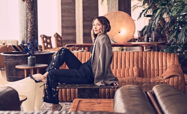 Kelly Wearstler in a modern lounge with warm leather seating.