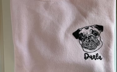 a pink shirt with a pug dog on it