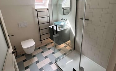 Bathroom with modern bathtub and vanity unit installed by PBP Services in Evesham