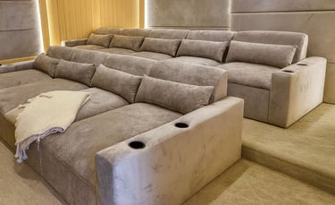Solo Home Decor custom theater sectional with plush reclined seats, cup holders, and warm lighting