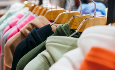 a bunch of clothes hanging on a rack of clothes