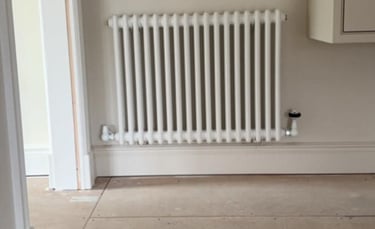 double-panel radiator being leveled and tested by PBP Services in Pershore