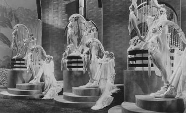 Three standing oversized harp props made of live women in a surreal Busby Berkeley musical number.
