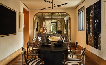 Kelly Wearstler design- dining room with a table and chairs.