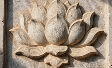 Photography of an intricate stone carving of a lotus on a temple wall. Soft shadows and a warm cream light highlighting the ancient craftsmanship.