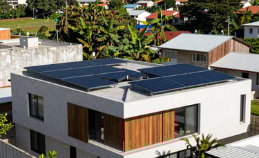 Modern photography of a stylish residential home in a South American urban neighborhood with high-tech solar panels installed on the roof. Bright, natural sunlight, professional architectural composition, emphasizing clean energy and sustainable living with lush light green vegetation in the background.
