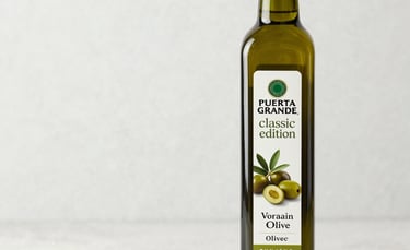 Selection of olive oil bottles with different labels and colors on a wooden table