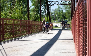 Photo of bikers coming over a bridge from the front of the pack