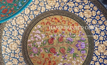Hand-painted Kashmiri papier-mâché decorative objects made by artisans using traditional techniques.