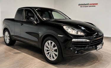 Porsche Cayenne transformado em picape preta de luxo em showroom automotivo.