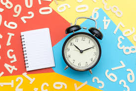 a clock and a notebook with numbers on it