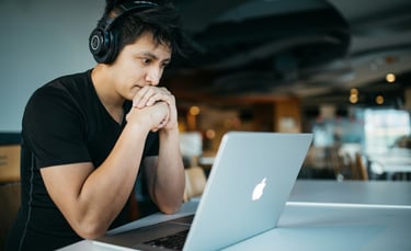 a man in headphones and headphones sitting at a table