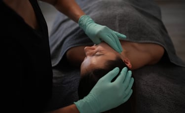 a woman getting a facial lift from a doctor masaż transbukalny policzkowy