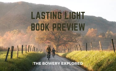 Gravel road in Cades Cove, Great Smoky Mountains, with two bikers during the fall by Nate Bowery
