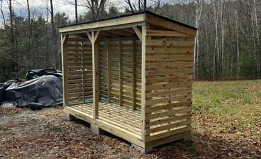 a chord of chopped wood logs stacked on top of each other in a wooden storage shed