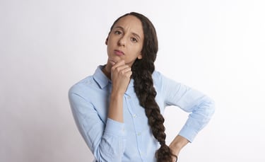 woman thinking thoroughly and wondering if gold ira is a scam