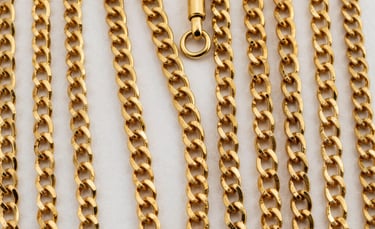 Stacked gold and silver rings catching the light on a minimalist white surface