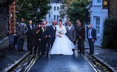newly-weds posing on a Hampstead street with their wedding guests