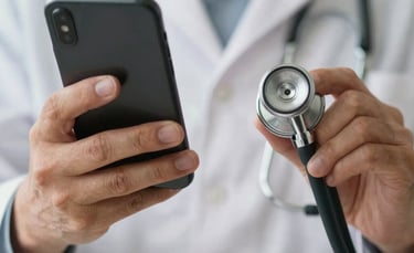 A close-up of hands holding a stethoscope and a smartphone, symbolizing the blend of traditional medicine and digital health technology, soft lighting.