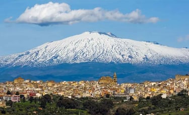Panoramic view of the hiSicily with the snow-capped Mount Etna volcano in the background.