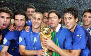 Italian soccer players Fabio Cannavaro and teammates celebrate holding the FIFA World Cup trophy.