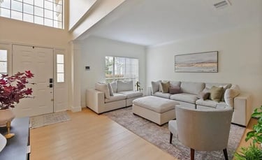 Living room with sectional seating, armchairs, and a front entry door.