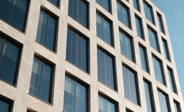 A low-angle, architectural photograph of a sleek North American office building with integrated solar glass panels. The scene is lit by bright, natural sunlight, reflecting off the Slate Blue and Off-white surfaces. The composition emphasizes clean lines and a contemporary tech-focused atmosphere.