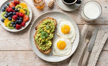 Balanced breakfast of fresh fruit, milk, eggs and avocado toast.