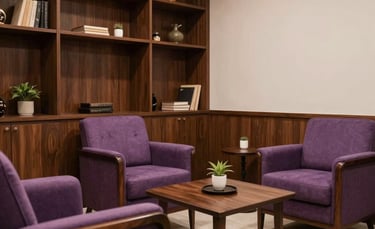 The interior of a peaceful and elegant Brazilian consultation room with dark wood furniture and soft purple accents. Professional and welcoming atmosphere.