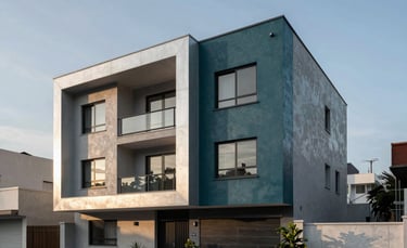 Modern residential house in a clean Latin American urban setting, professional architectural photography, soft morning sunlight, deep teal and silver gray tones in the building materials.