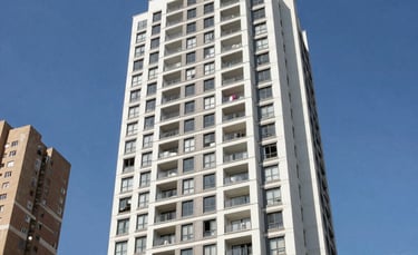 Professional photography of a modern high-end residential apartment building in a Brazilian metropolitan area, clear blue sky, bright daylight, architectural clean lines.