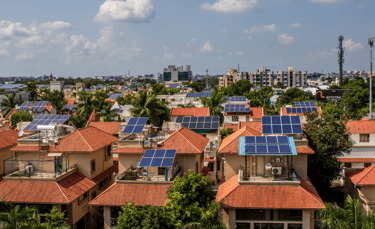 a cityscape of houses with solar panels on the roof