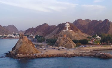 Vista do porto de Muscat com montanhas ao fundo, chegando de navio ao amanhecer.