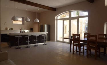 Open-plan kitchen and dining area renovated with modern finishes and natural light